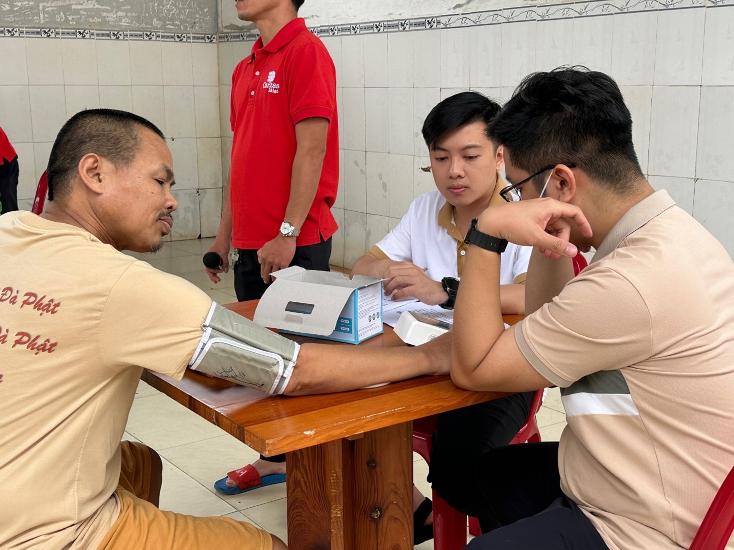 A group of men sitting at a tableDescription automatically generated