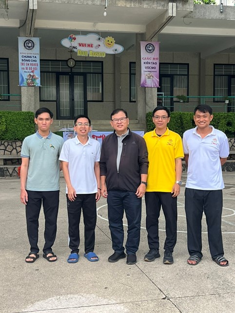 A group of men standing in front of a buildingDescription automatically generated