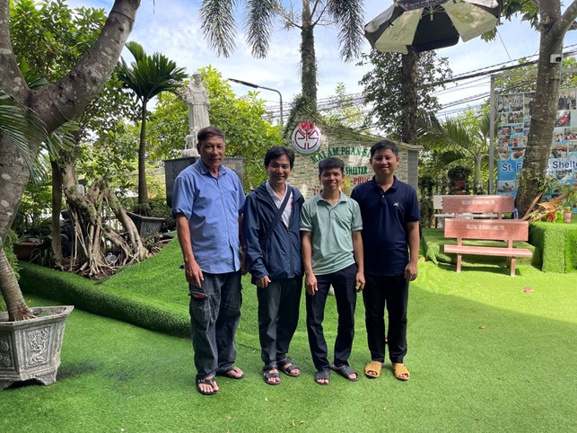 A group of men standing on a grass fieldDescription automatically generated