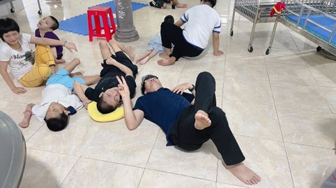 A group of people lying on the floorDescription automatically generated