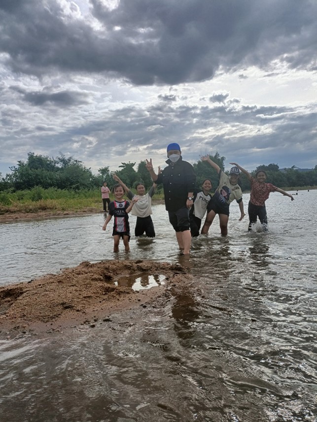 A group of people standing in waterDescription automatically generated